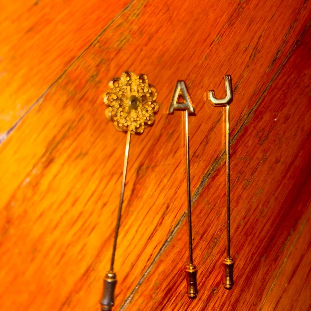 Vintage brass tie pins with floral design and letter 'A' and 'J'